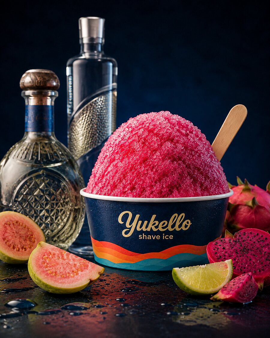 Guava Glow after dark — deep pink shave ice with guava, lime and crystal spirit bottles