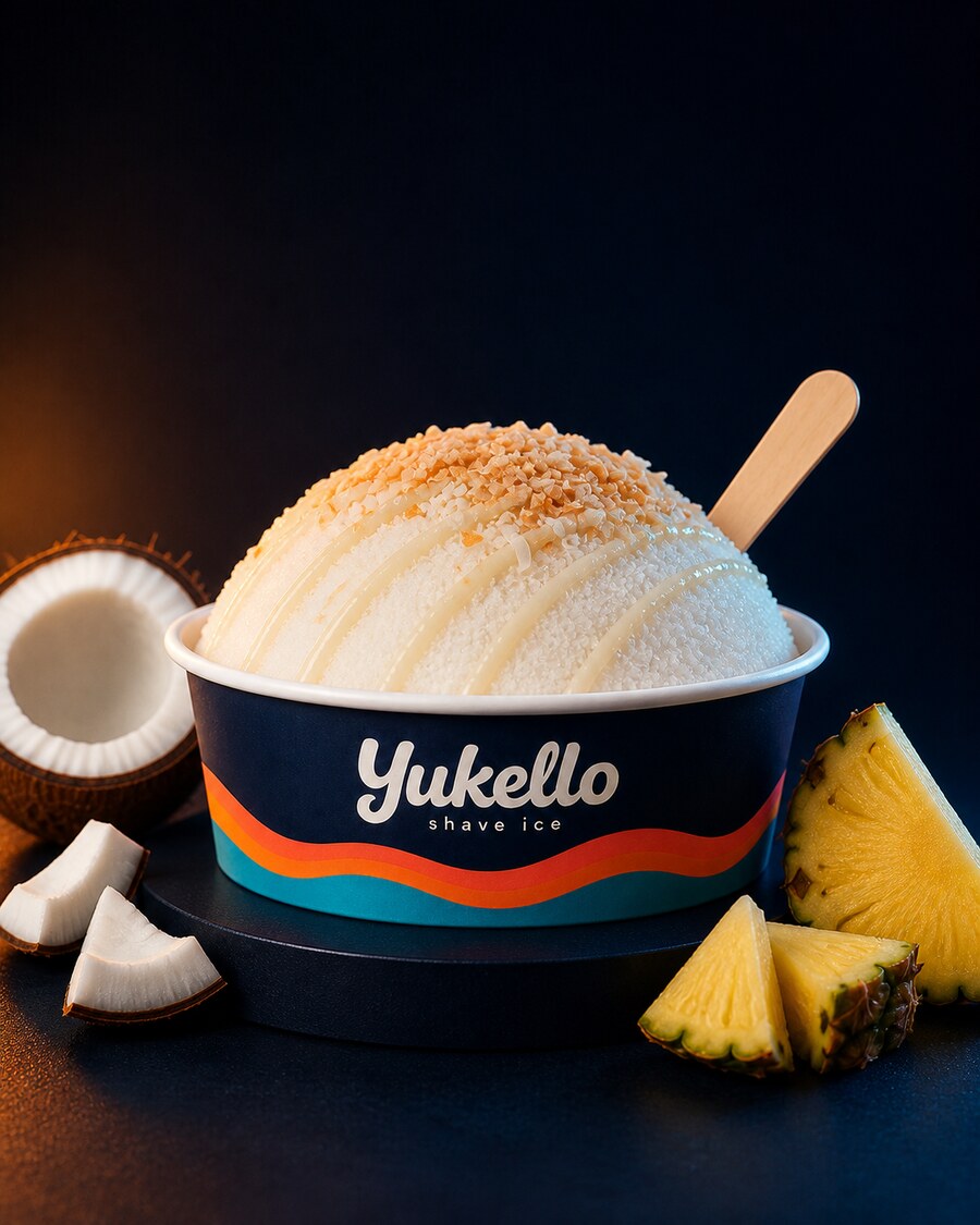 Coconut Cloud shave ice — white snow with toasted coconut and pineapple in a navy Yukello bowl