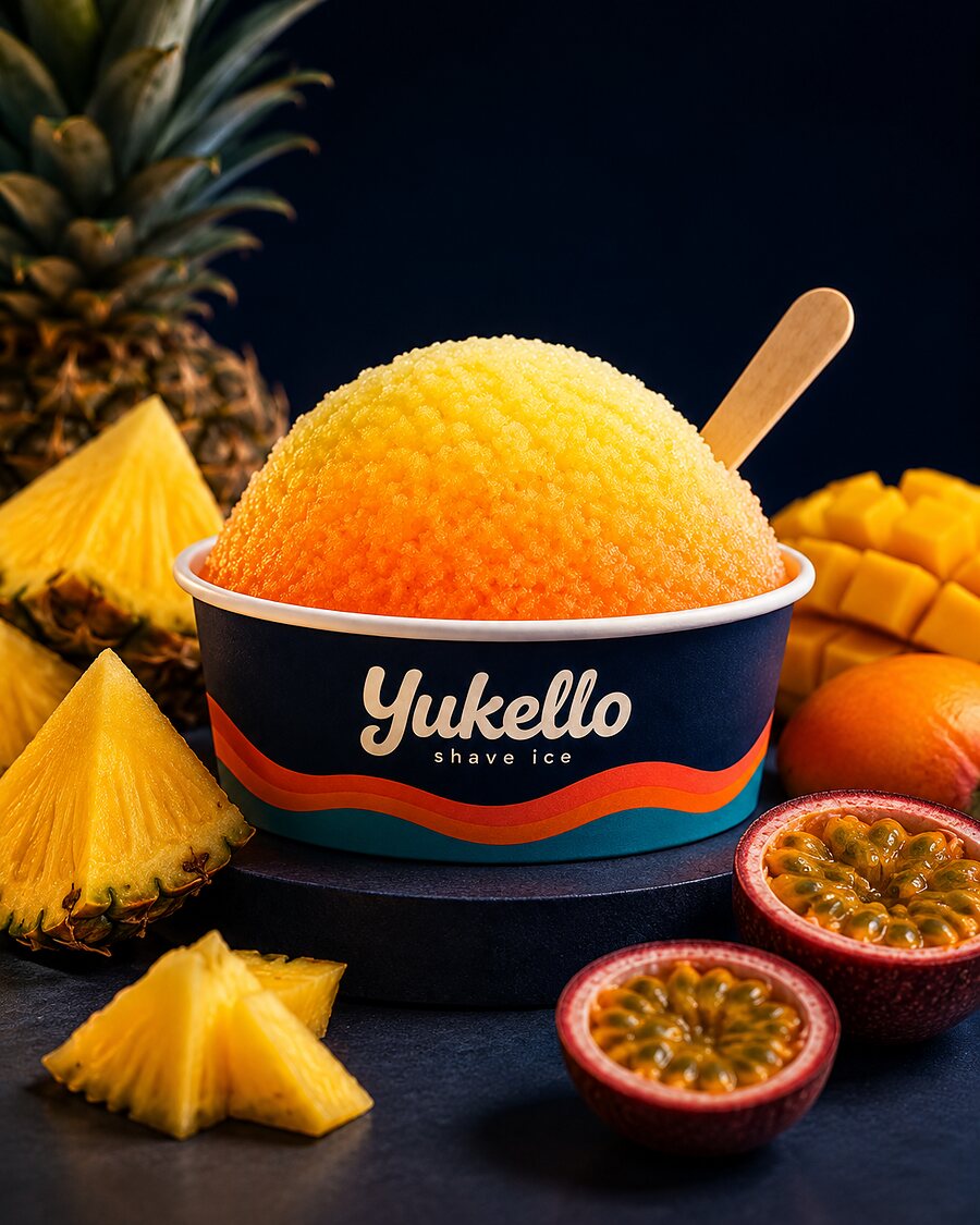 Golden Sunrise shave ice — golden snow in a navy Yukello bowl with fresh pineapple, mango and passion fruit