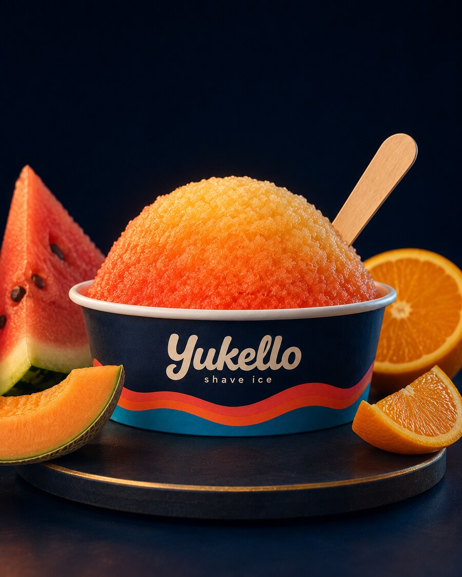 Melon Sunset shave ice — coral and gold snow in a navy Yukello bowl with watermelon, cantaloupe and orange