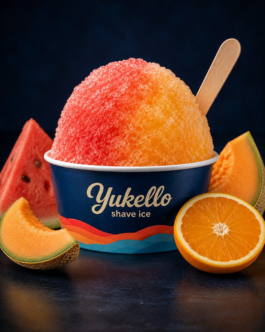 Melon Sunset shave ice — coral and gold snow in a navy Yukello bowl with watermelon, cantaloupe and orange